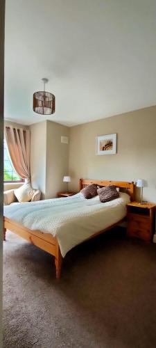 a bedroom with a large bed in a room at Rynn Haven - Enchanting Townhouse Lough Rynn in Mohill