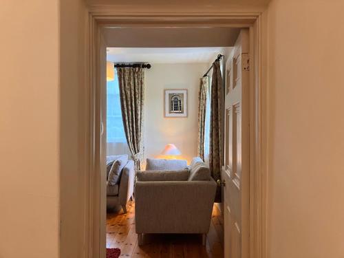 a living room with a couch and a chair at Plas yn Yale with mountain views from all windows in Wrexham