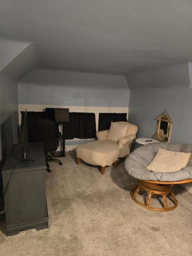 a living room with a couch and a television at Unit 2 at Oilgate at Oakdale in Akron