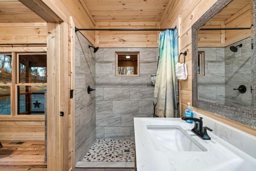 a bathroom with a shower and a white sink at 4br Cabin In Sevierville Mountain Views, Hot Tub in Pigeon Forge