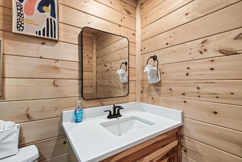 a bathroom with a white sink and a mirror at 4br Cabin In Sevierville Mountain Views, Hot Tub in Pigeon Forge