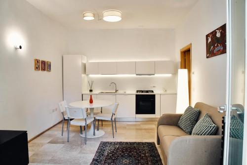 a kitchen and living room with a table and a couch at Dormi da noi in Ancona