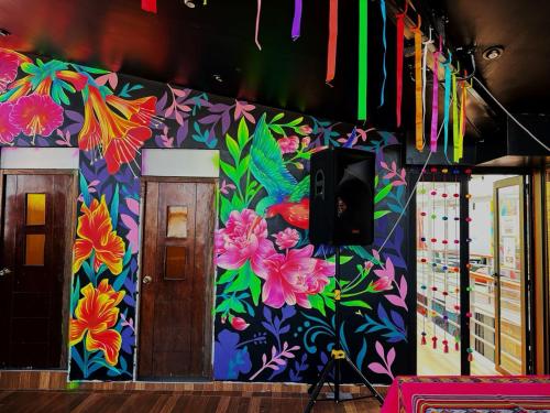 a colorful wall with a flower design on it at Magic Packer Hostel in Cusco