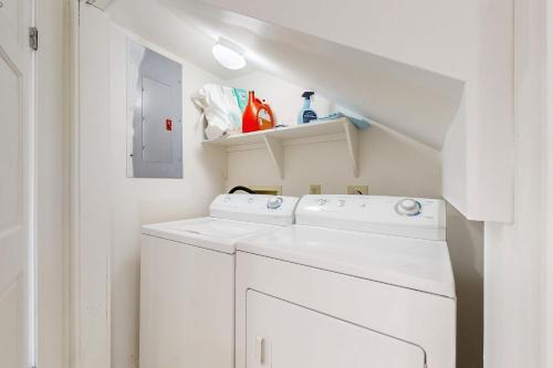 a white laundry room with a washer and dryer at Hawkins Lookout in Cudjoe Key