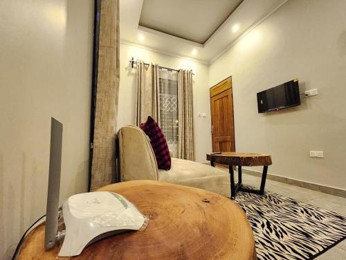 a living room with a table and a couch at Moshi Epic Accommodation in Moshi