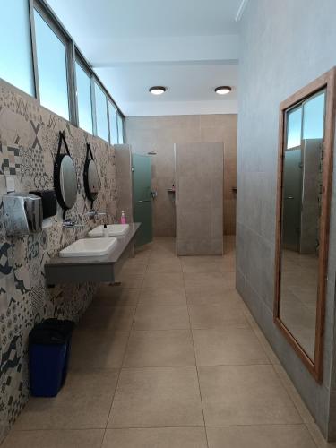a bathroom with two sinks and a shower at Skynest Residences by Lisa's Paradise in Nairobi