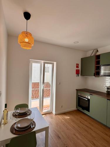 a kitchen with a table with plates on it at Salty Apartments in Nazaré