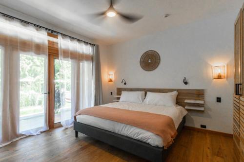 a bedroom with a bed and a large window at S Boutique Hotel in Bocas del Toro