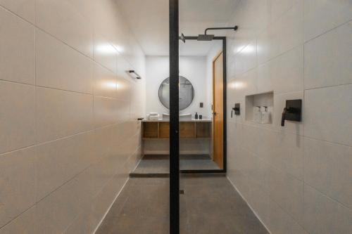 a hallway with a mirror and a sink in a bathroom at S Boutique Hotel in Bocas del Toro