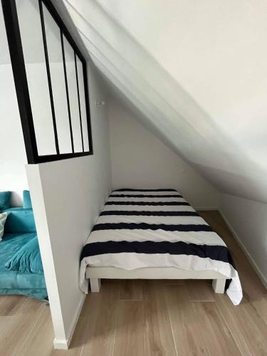 une chambre avec un lit et une fenêtre dans l'établissement STUDIO BORD DE MER LOMENER, à Ploemeur