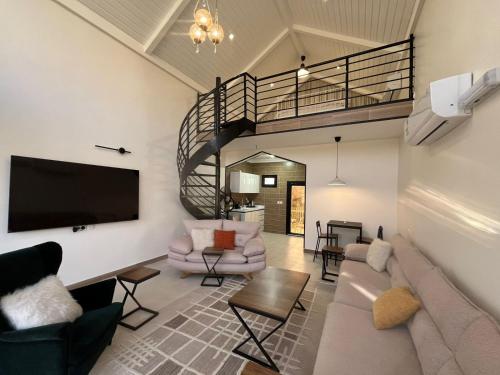 ein Wohnzimmer mit Couch und Fernseher in der Unterkunft أكواخ مزرعة ريف عبس in Al ‘Orosh
