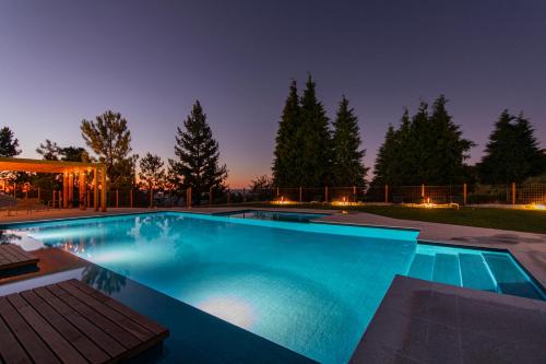 a swimming pool in a backyard at night at TerraSena Mountain Village - Serra da Estrela in Seia