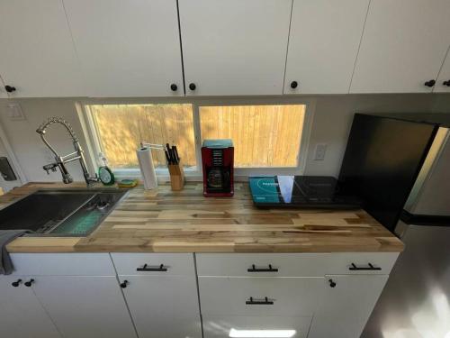 a kitchen with a counter top with a sink at 1Bed 1Bath Container Home Centrally Located in Cypress Gardens