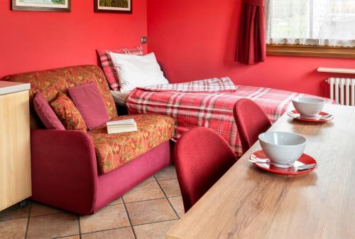 a room with a table and a chair and a bed at Chalet Rosita in Livigno