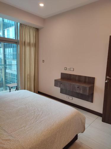 a bedroom with a large bed and a large window at Skynest Residences by Lisa's Paradise in Nairobi