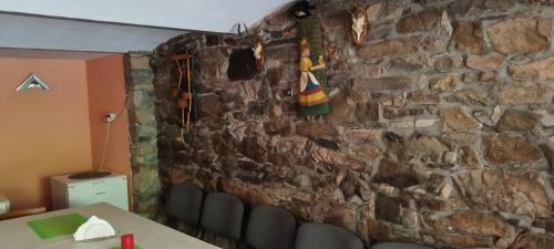 a stone wall with a table and chairs in a room at Rancho u Bolka in Miedzygorze