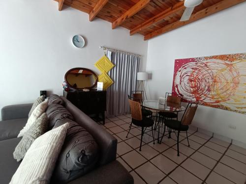 a living room with a couch and a table at Adventure Inn La Paz in La Paz