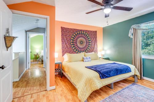 a bedroom with a bed with an orange wall at Blacksburg Hideaway with Hot Tub about 5 Mi to Campus! in Blacksburg