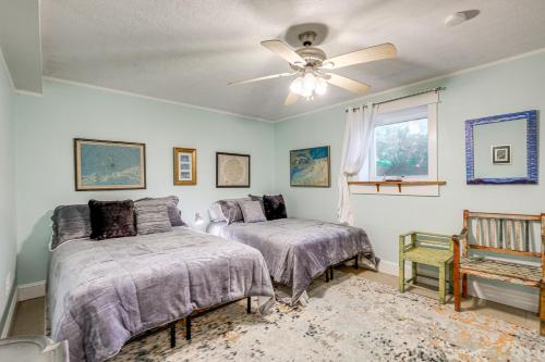 a bedroom with two beds and a ceiling fan at Blacksburg Hideaway with Hot Tub about 5 Mi to Campus! in Blacksburg