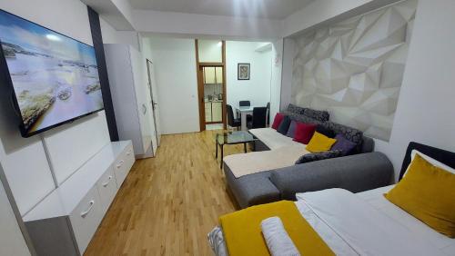 a living room with a couch and a bed at Petreski Apartments 1 in Ohrid
