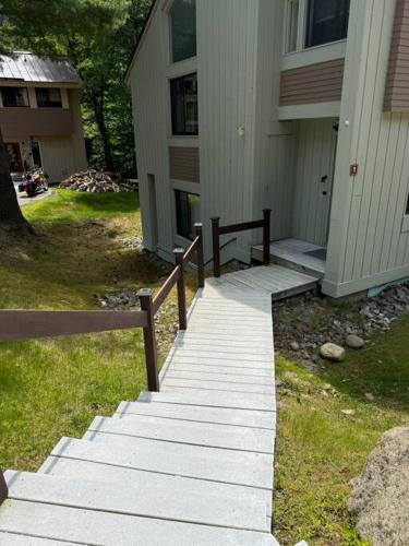 a stairway leading to a house with a building at Pet Friendly Condo near Loon with Loon Club passes in Lincoln