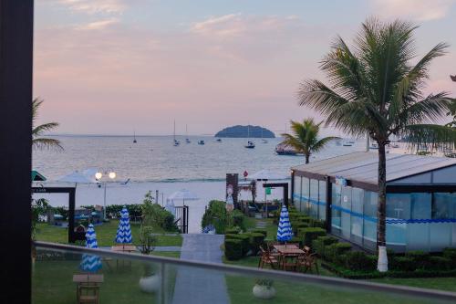 a view of the ocean with boats in the water at Hotel Sete Ilhas in Florianópolis