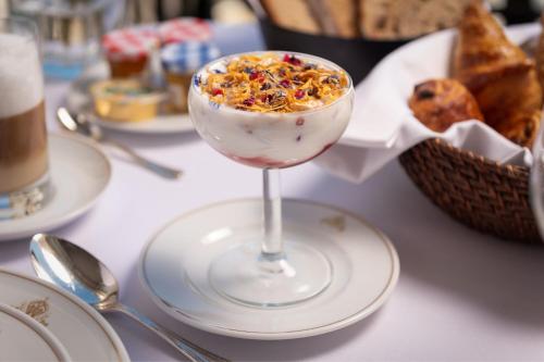 a drink in a glass on a plate on a table at Hotel Maria Cristina, a Luxury Collection Hotel, San Sebastian in Donostia-San Sebastián