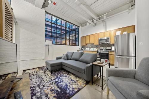 a living room with a couch and a kitchen at 2125 Superior Living in Cleveland