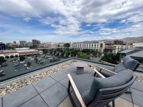 a balcony with two chairs and a view of a city at Iconic Nike Studio & Romantic Canopy Glow in Boise