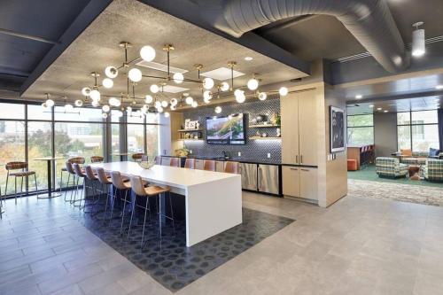 a dining room with a long table and chairs at Iconic Nike Studio & Romantic Canopy Glow in Boise