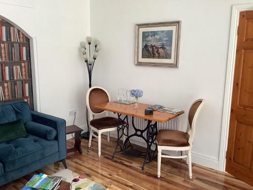 a living room with a table and a blue couch at O' Sullivan's B & B in Killarney