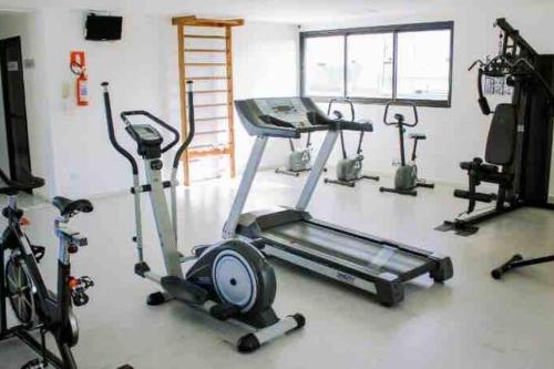 a gym with several exercise bikes and a treadmill at O EDIFÍCIO é de frente ao MAR de Pajuçara NEO 2 Qts 2gar - Adm Nutelss in Maceió