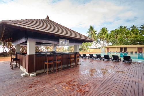 a bar on a deck next to a swimming pool at Turyaa Kalutara in Kalutara