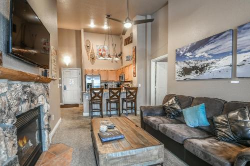 a living room with a couch and a fireplace at Hidden River Lodge 5981 by SummitCove Lodging in Keystone