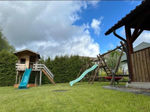 a playground with two slides and a play structure at ATENY NIEGRECKIE Dom Wczasowy in Ateny