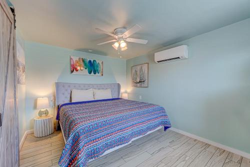 a bedroom with a bed and a ceiling fan at Casa Mariposa SPV19 in Port Aransas
