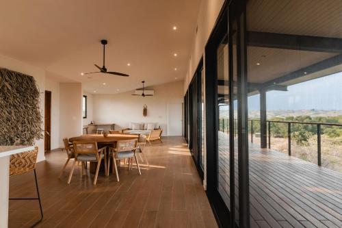 a dining room and kitchen with a table and chairs at Villa Almanglar - Tropical Home with Pool and Views in Playa Venao