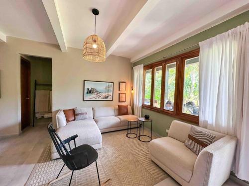 a living room with a couch and a table at Villa Perla A Surfer's Dream in Playa Venao