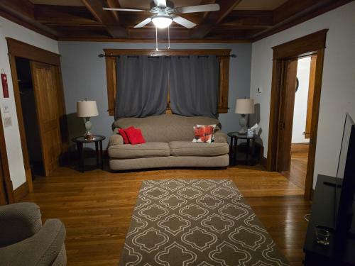 a living room with a couch and a ceiling fan at Unit 1 at Oilgate at Oakdale in Akron