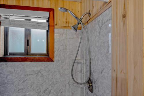 a shower with a shower head in a bathroom at Secluded Tahoe Retreat Near Trails and Beach in Carnelian Bay