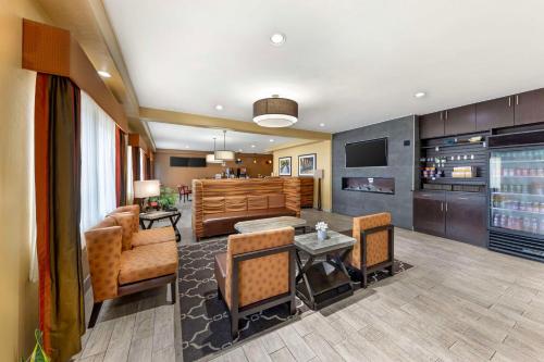 a living room with a couch and a table and chairs at Best Western Greentree Inn & Suites in Moore