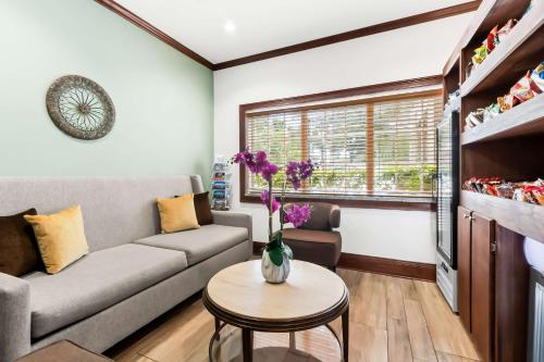 a living room with a couch and a table at Best Western Patriots Point in Charleston