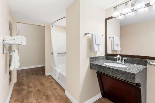 a bathroom with a sink and a shower at Best Western Patriots Point in Charleston