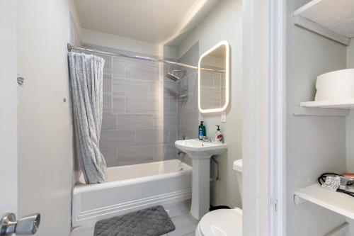 a bathroom with a sink and a tub and a toilet at Luxurious 6 bedroom villa near downtown in San Antonio