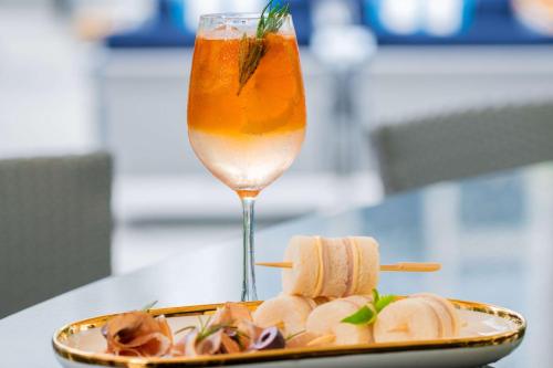 a plate of food and a drink on a table at Park Plaza Bangkok Soi 18 in Bangkok