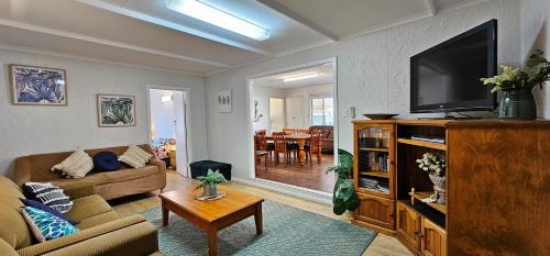 a living room with a couch and a television at Patrick Crescent 18 - Kalbarri, WA in Kalbarri