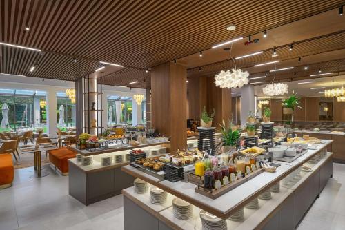 a buffet line with food on display in a restaurant at Radisson Hotel Plovdiv in Plovdiv