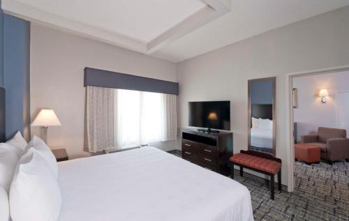 a hotel room with a large bed and a television at Best Western Plus Hotel & Conference Center in Baltimore