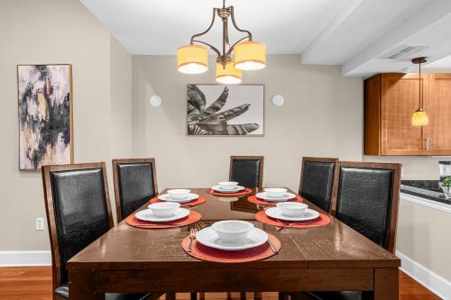 a dining room with a wooden table and chairs at 4BR Disney Family Townhouse Resort in Orlando - with Resort Pool, Gym, Games, & Jacuzzi in Orlando