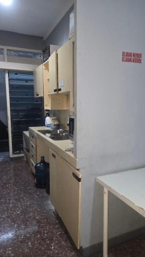 a kitchen with white cabinets and a counter top at Omajo bedrooms in Semarang